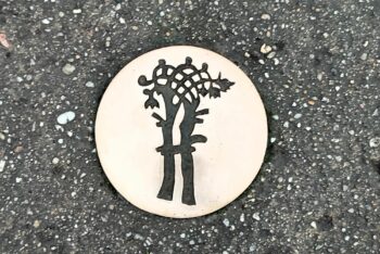 Bronze marker on the ground to follow the Heritage Trail in Bayeux, Normandy